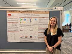 HPTM Student Riley Watson smiling at the camera during his poster presentation at the 2025 GSBS Research expo